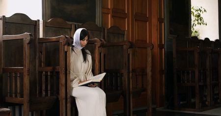 Orthodox Christian woman reads holy scripture in traditional church. Captures moment of deep faith...