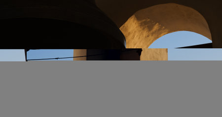 In historic church, bell ringer sounds bells, filling air with a call to prayer. Echoes create an atmosphere of reverence, uniting believers in devotion to faith.の写真素材