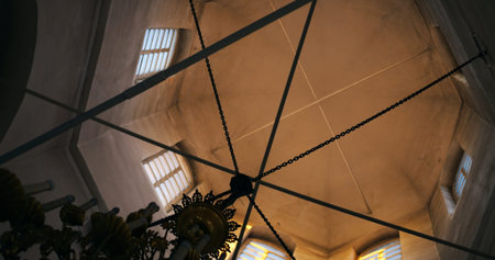 Tower interior showcasing symmetrical window patterns and cross-shaped beams. Play of light and...