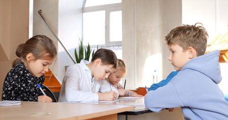 Students collaborating on classroom project, working together with focus and engagement,...