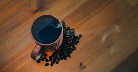 Steaming coffee mug on wooden tabletop, coffee filling frame with rich aroma, coffee invoking warm morning ritual, clip for beverage ads, cafe branding lifestyle inspiration, social content worldwideの写真素材