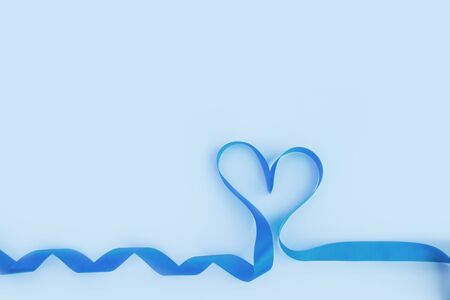 Top view of ribbon shaped as heart on blue background. Valentine's day conceptの写真素材