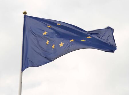 European Union flag flying in front of bright blue sky.の写真素材