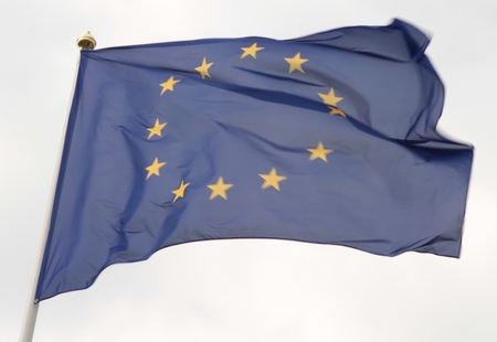 European Union flag flying in front of bright blue sky.の写真素材