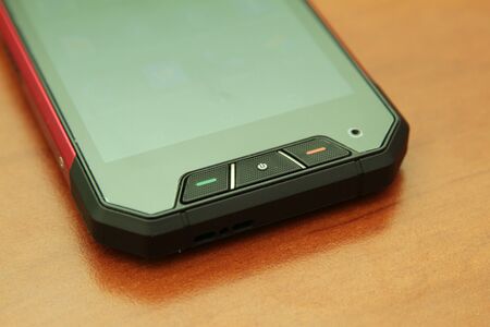 Protected mobile phone on a wooden table.の写真素材