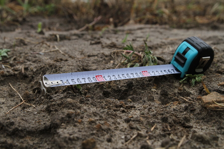 Building rouletteon, outdoors. Construction roulette on the land. Earth measurementの写真素材