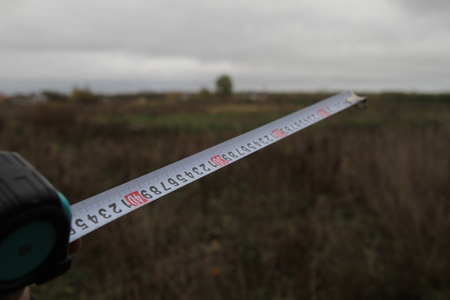 Building rouletteon, outdoors. Construction roulette on the land. Earth measurementの写真素材