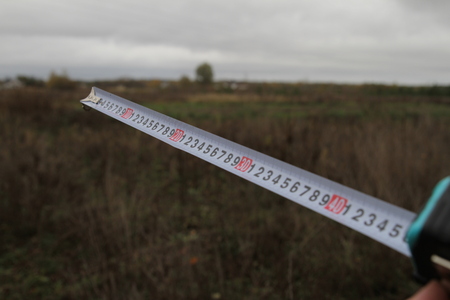 Building rouletteon, outdoors. Construction roulette on the land. Earth measurementの写真素材