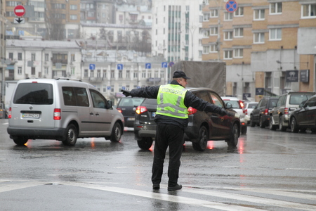 Kiev, Ukraine - November 29, 2017. Policeman regulates traffic at the crossroads in Kiev.のeditorial素材