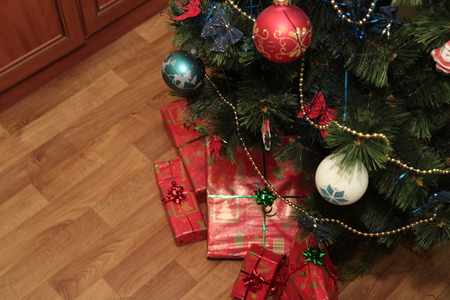 Happy cute little baby in Santa's costume near Xmas tree decorating.の写真素材