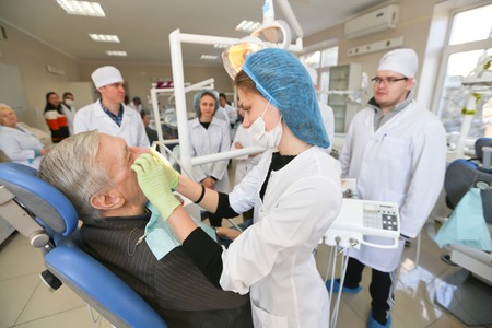 Students practicing dentistry on medical dummies in a teaching facility or universityのeditorial素材