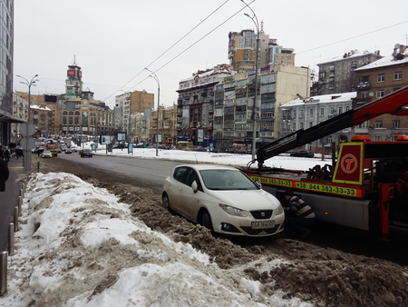 Kiev, March 6, 2018, Ukraine. The police evacuate the car from the roadway. Violation of traffic rules. Snow on the winter road.のeditorial素材