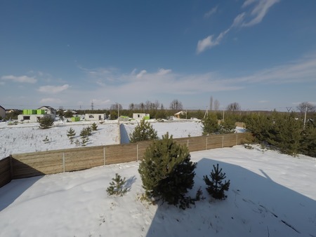 Plot of land in winter. Construction of a private house. Fence on the land in winter.の写真素材