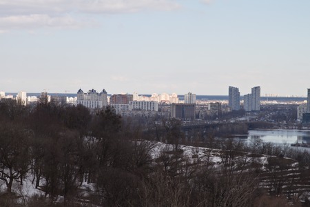 View of the city and real estate through the winter river in the ice.の写真素材
