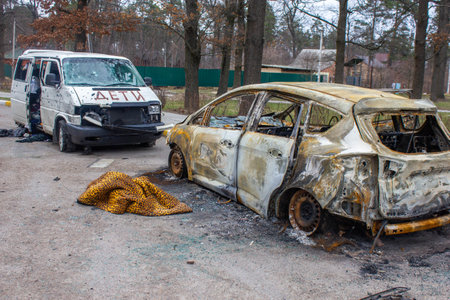 Bucha, Kyiv region, Ukraine - April 5, 2022: War between Russia and Ukraine. The consequences of the war, the damaged car of civilians by the troops of the Russian army. shot car.のeditorial素材