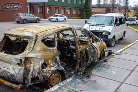 Bucha, Kyiv region, Ukraine - April 5, 2022: War between Russia and Ukraine. The consequences of the war, the damaged car of civilians by the troops of the Russian army. shot car.のeditorial素材
