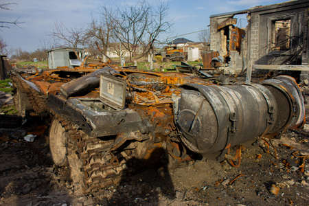 Velyka Dymerka, Kyiv region, Ukraine - April 2022: War Ukraine Russia. The ruins of the house after the bombing by the Russian army. Destroyed tank and house after a missile attack. The consequences oのeditorial素材