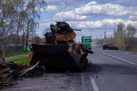 Kolychevka, Ivanovka, Chernihiv region - Apr 2022: War Ukraine Russia. The ruins of the house after the bombing by the Russian army. Destroyed tank and house after a missile attack.のeditorial素材