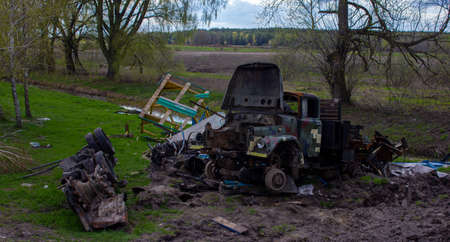 Kolychevka, Ivanovka, Chernihiv region - Apr 2022: War Ukraine Russia. The ruins of the house after the bombing by the Russian army. Destroyed tank and house after a missile attack.のeditorial素材