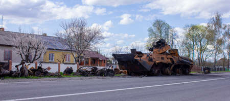 Kolychevka, Ivanovka, Chernihiv region - Apr 2022: War Ukraine Russia. The ruins of the house after the bombing by the Russian army. Destroyed tank and house after a missile attack.のeditorial素材