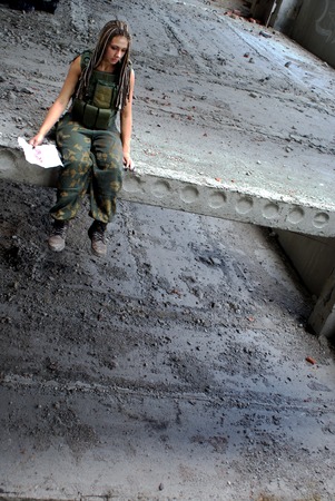 The woman in a military uniform. A back background. Grief. Memoirsの写真素材