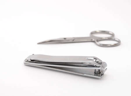 Nail clipper and scissors on a white backgroundの写真素材