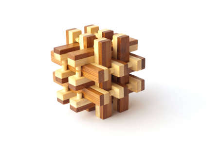 Isolated 3D wooden puzzle constructed from 18 wooden piecesの写真素材
