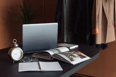 Laptop and businesses details on table, work place of designerの写真素材
