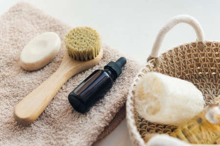 cosmetics products in bathroom - towel, serum dropped bottle, face brush and exfoliation soapの写真素材