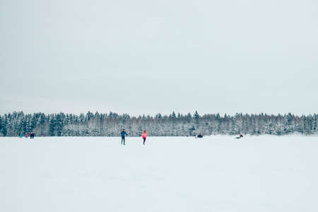 people skiing in the winter forestの写真素材