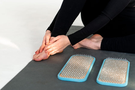 Alternative medicine and mindfulness practice - standing on sadhu board nails barefoot