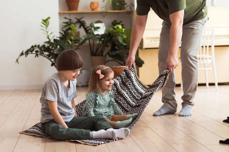 father playing with children - son with Down syndrome and daughterの写真素材
