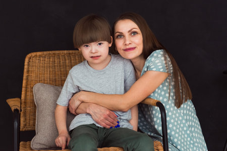 Loving mother embracing boy with Down syndromeの写真素材