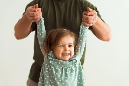 Loving father playing cute daughter