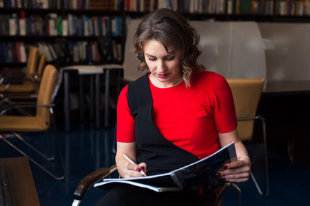 professional woman educator or manager working at public library of high school or college