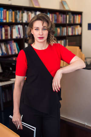 professional woman educator or manager posing at public library of high school or collegeの写真素材