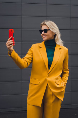 Happy smiling woman using smartphone, enjoying lifeの写真素材