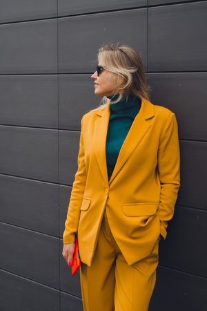 Beautiful fashion woman posing at gray city wall background, enjoy life conceptの写真素材