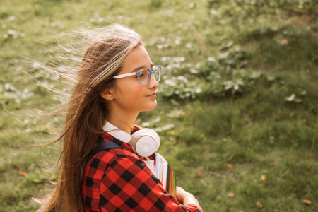happy teen girl student in headphones street style portraitの写真素材