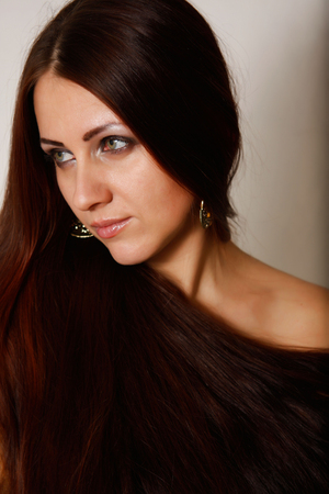 The picture shows a beautiful girl with long brown hair.の写真素材