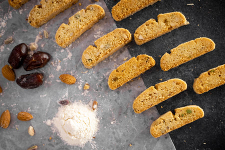 Freshly baked homemade cookies on oven tray rack on dark background flat layの写真素材