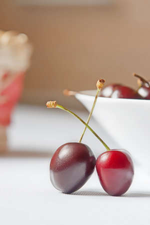pair of sweet cherries on white tableの写真素材