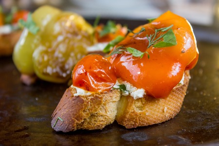 Bruschetta with cherry tomatoes, sweet pepper, mozzarella cheese and marjoramの写真素材