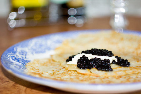 Black caviar on Russian pancakes. Selective focus.の写真素材