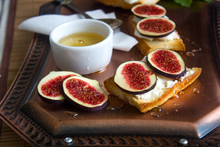 Bruschetta with goat cheese and figs on a coppet tray.の写真素材