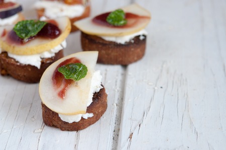 Bruschetta with goat cheese, pear and figs.の写真素材