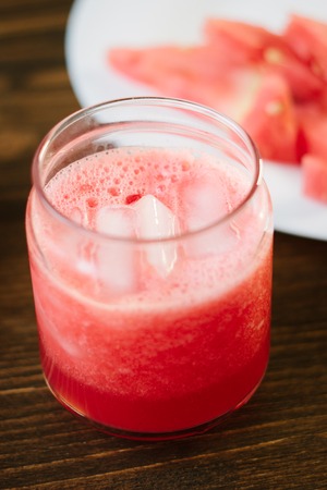 Delicious watermelon smoothie on the wooden board. Smoothie - vegetarian coctail from fresh fruit - watermelon.の写真素材