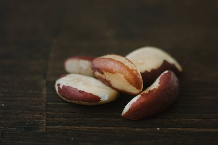Heap of brazil nuts over the brown wooden tableの写真素材