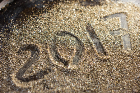 2017 year concept. Numbers 2017 on the gold sand texture