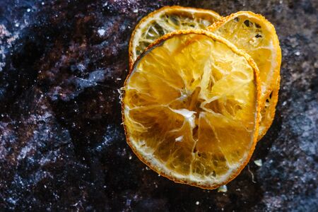 Dried orange over the black metal boardの写真素材